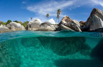Underwater split view with turquoise waters, palm trees and giant rocks, The Baths, Virgin Gorda, British Virgin Islands, Caribbean